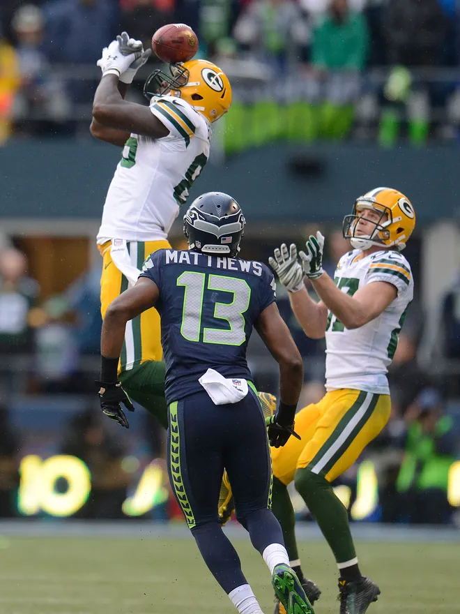 The Dallas Cowboys' Brandon Carr, left, looks on as teammate Dez Bryant  looks to the replay and shows his frustration after being penalized for  interference and removing his helmet late in the